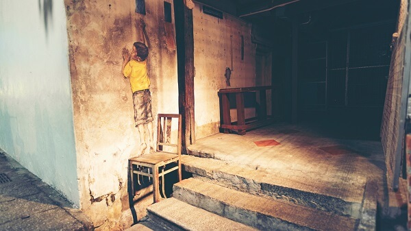penang street art boy on a chair